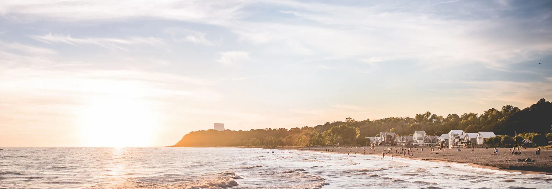 Sunset over the main beach in Port Stanley, with the bluffs and beach houses along the shore